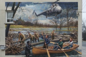 mural of a plane and people in a canoe escaping a flood
