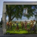 mural of men and women in old-fashioned dress playing golf